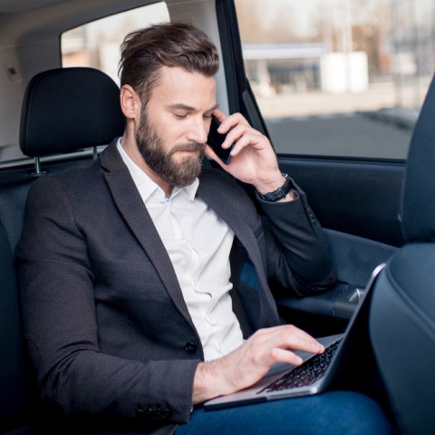 Man on Phone in Black SUV