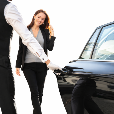 Women getting into luxury car