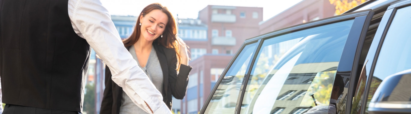 Women getting into luxury black car